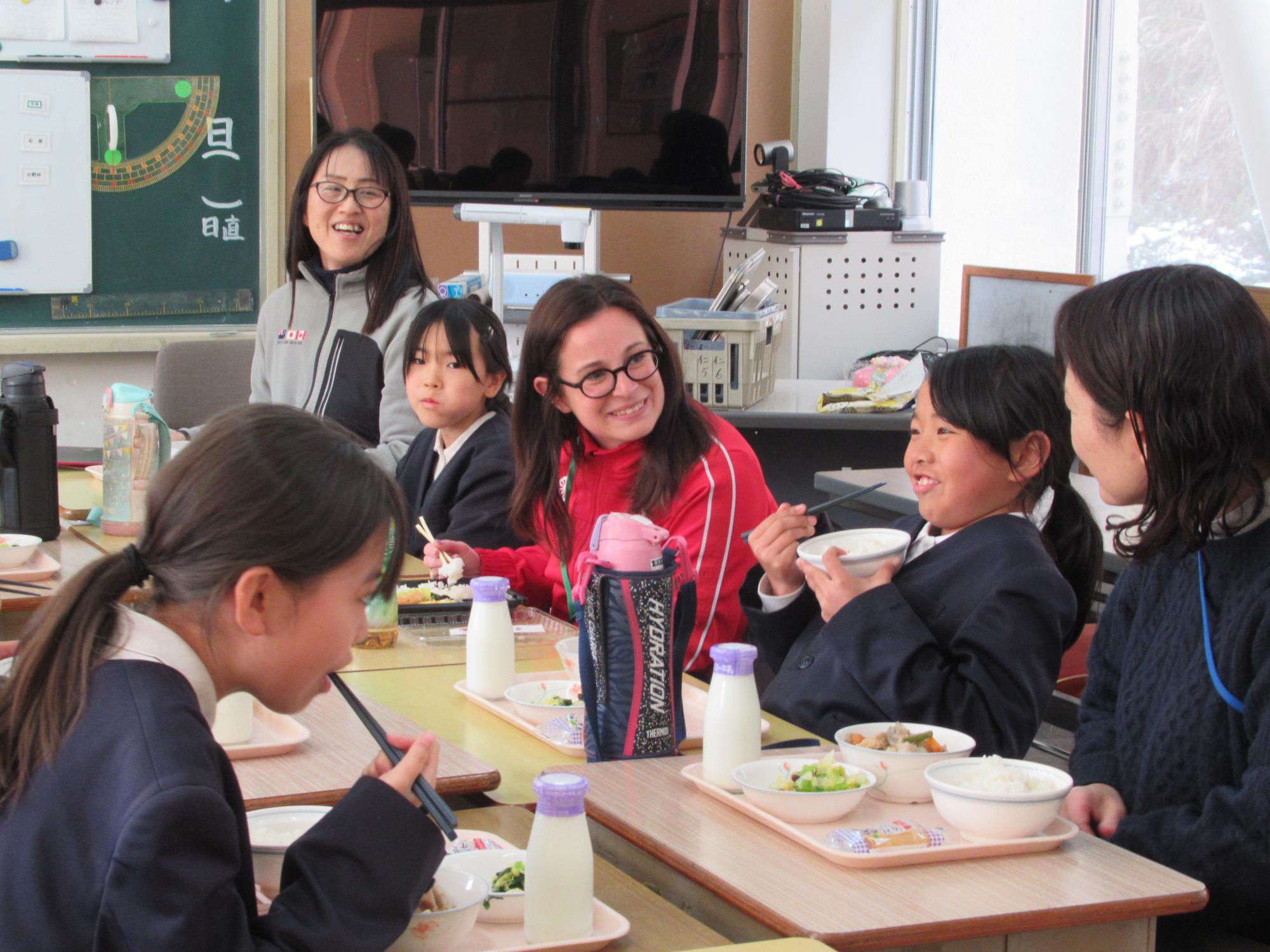 小学生と一緒に給食を食べるカナダコーチ